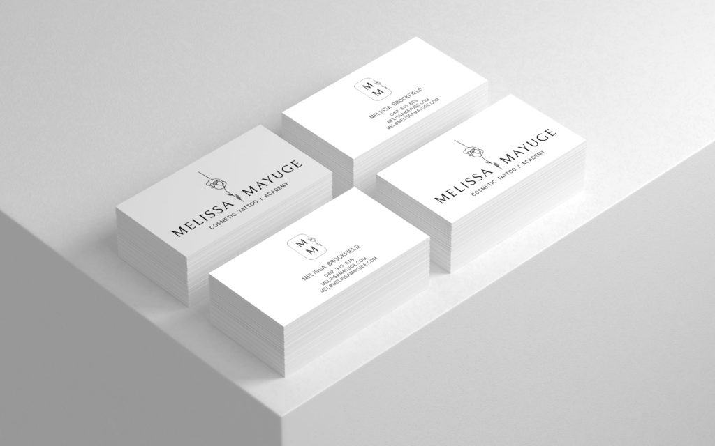 Three white business cards on top of a white surface representing a WordPress Website Design developer from Gold Coast.
