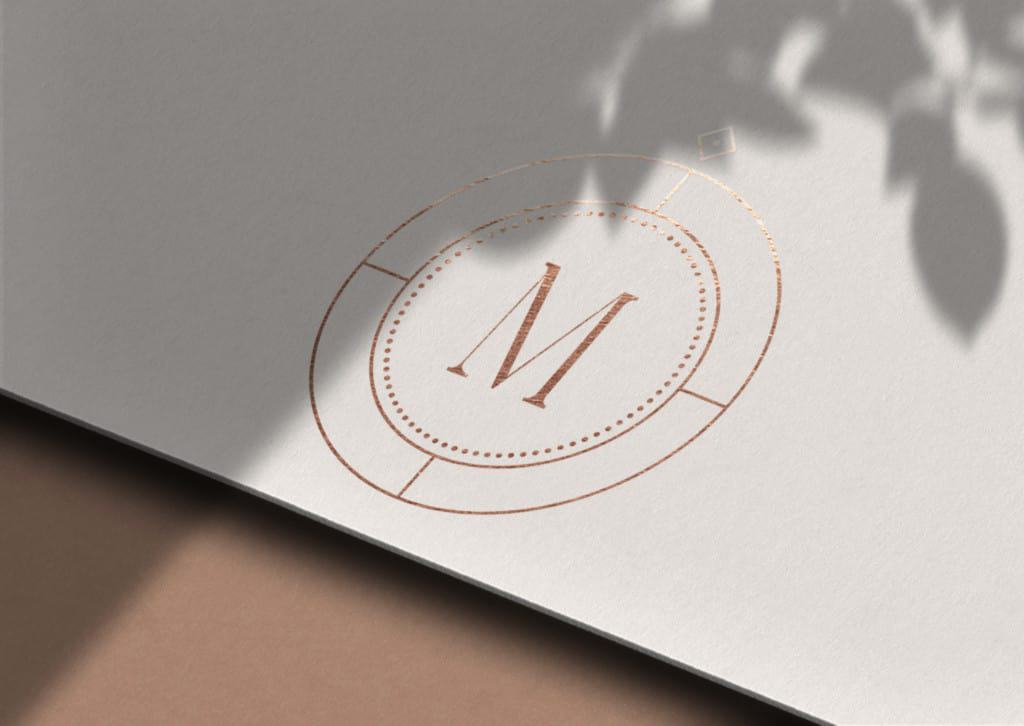 A logo mockup with the letter m on a white background for Seedling Digital's brand design.
